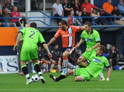 Stuart Fleetwood takes on three Darlington defenders