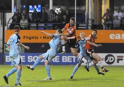 Janos Kovacs gets above Josh Coulson to win a header