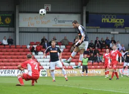 Robbie Willmott leaps high to head in his and Town`s second goal