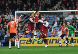Janos Kovacs is outnumbered three to one as he clears the ball