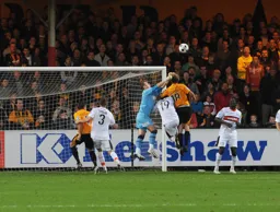 Kevin Pilkington punches clear under pressure from future Hatter Luke Berry