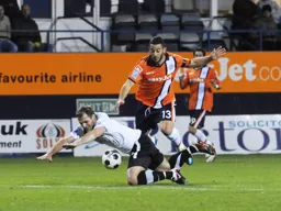 Stuart Fleetwood is blocked by a falling defender