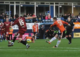 Adam Watkins shoots from the edge of the penalty area