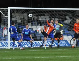 Stuart Fleetwood hooks the ball into the net for the first goal