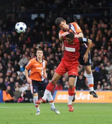 George Pilkington heads the ball clear