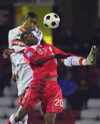 Shane Blackett rises above Jamille Matt to win a header