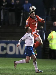 Greg Taylor gets above his man to head the ball clear