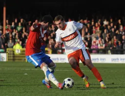Greg Taylor tries to wrong foot a defender