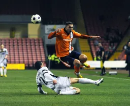 Greg Taylor leaps over Paul Arnison