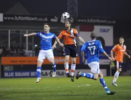 George Pilkington heads the ball away from former Hatter Jason Walker