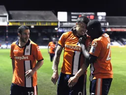 Stuart Fleetwood and Godfrey Poku congratulate Craig McAllister after scoring his goal