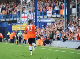 Stuart Fleetwood celebrates with the crowd in the enclosure after scoring the fourth goal