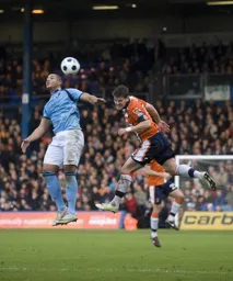 Simon Ainge heads the ball clear