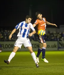Alex Lawless heads the ball down