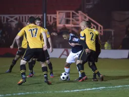 Stuart Fleetwood tries to wriggle his way past David Pipe