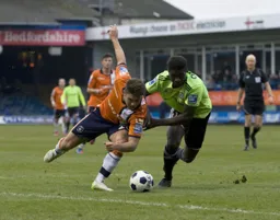 Scott Neilson looks for a way past Eddie Oshodi