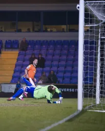 Stuart Fleetwood sees this attempt strike the frame of the goal