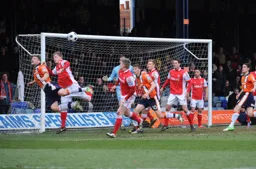 Simon Ainge heads the ball across the goalmouth