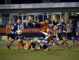 Grimsby scramble the ball away from Dave Martin and Andre Gray