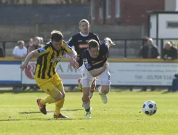 Dave Martin in a race for the ball with Aaron Chambers