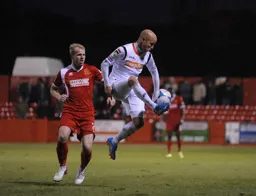 Luke Guttridge jumps to control the ball