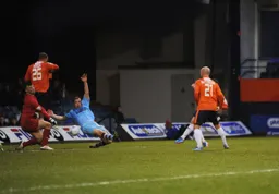 Alex Lawless (obstructed) slides in the Town's second