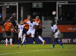 Steve McNulty gets in a header watched by Luke Wilkinson and Ross Lafayette