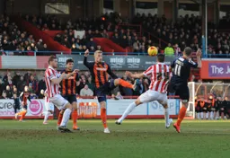 Jayden Stockly and Jake Howells challenge watched by Jonathan Smith