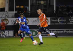 Luke Guttridge moves forward as Freddy Moncur moves in to challenge