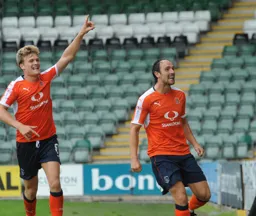 Danny Hylton looks happy after scoring the first goal.He is joined by Cameron McGeehan
