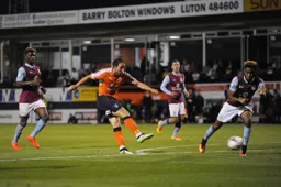 Danny Hylton tries a shot from the edge of the penalty area