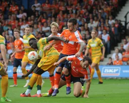 Bevis Mugabi gets to grips with Danny Hylton and Jack Marriott