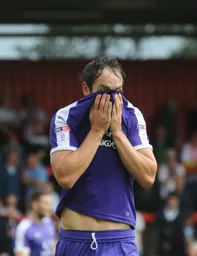 Danny Hylton wipes the sweat away from his face