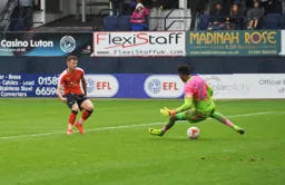 Jordan Cook slides the ball under the keeper for the Towns fourth