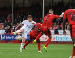 Jordan Cook tries to squeeze the ball through