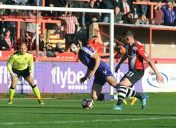 Danny Hylton is fouled to win his first penalty of the game