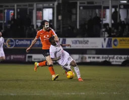 A masked Danny Hylton puts his opponent under pressure