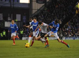 Danny Hylton forces his way between two defenders