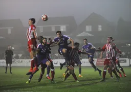 Josh McQuiod and Dan Potts look to attack a high ball
