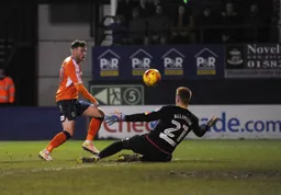 Jordan Cook goes for goal