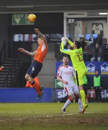 Glen Rea tries to beat the keeper in the air
