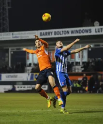 Danny Hylton jumps for the ball
