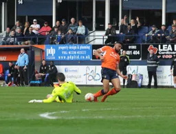 Chris Day comes a long way out of the penalty area to foil Isaac Vassell