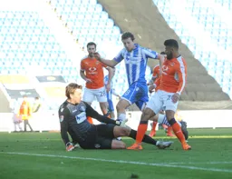 Isaac Vassell pokes the ball past the keeper for Town's consolation goal