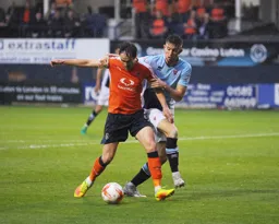 Danny Hylton protects the ball under pressure