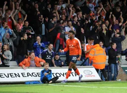 Isaac Vassell celebrates scoring the fifth goal in front of the Oak Road faithful