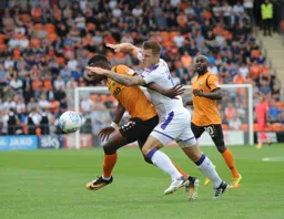 James Collins is blocked in an attempt to win the ball