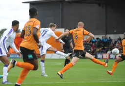 Andrew Shinnie`s shot bisects two defenders