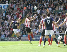 Luke Berry heads the ball towards the goal