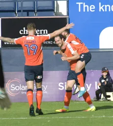 Danny Hylton gives Luke Gambin a piggyback ride after scoring the afternoon`s only goal